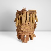 Stoneware ceramic, dry ochre and brown glazes over carved surface, the lid with scene of carved beasts, huts and towers, three carved flowers around the edge made by Ian Godfrey